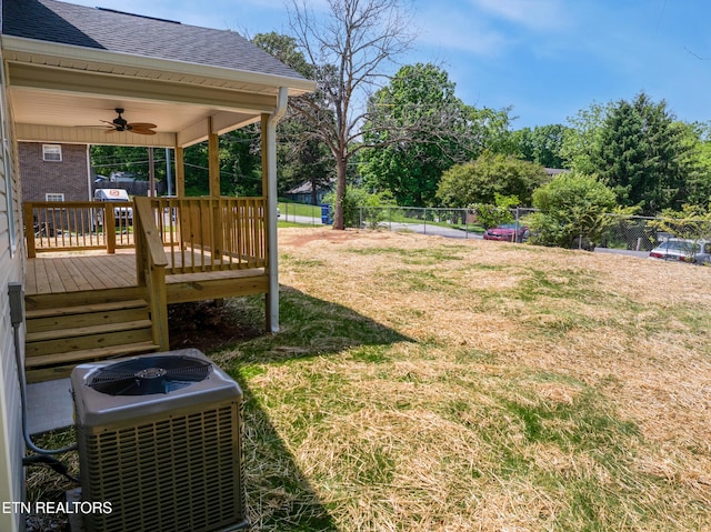 view of yard with a deck, central AC, a ceiling fan, and a fenced backyard