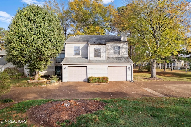 garage featuring concrete driveway