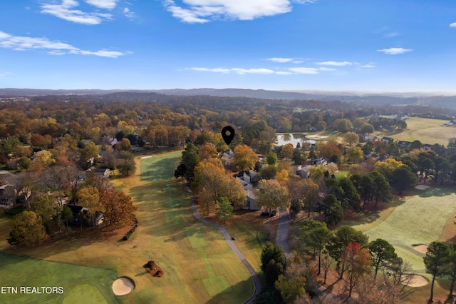 drone / aerial view featuring a view of trees and view of golf course