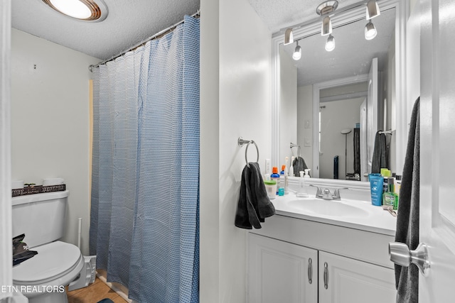full bathroom with toilet, a textured ceiling, a shower with curtain, and vanity