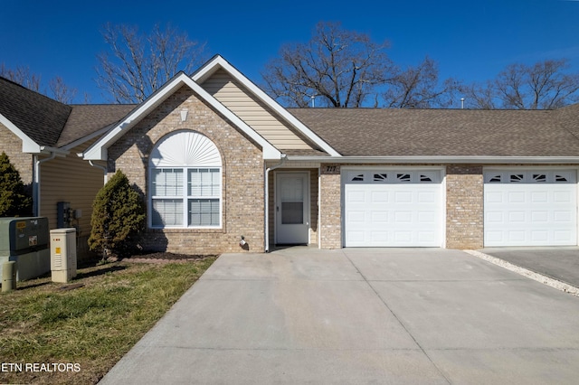 single story home with roof with shingles, an attached garage, concrete driveway, and brick siding