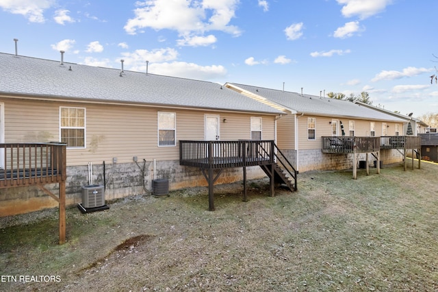 rear view of property featuring a deck, central AC, and stairway