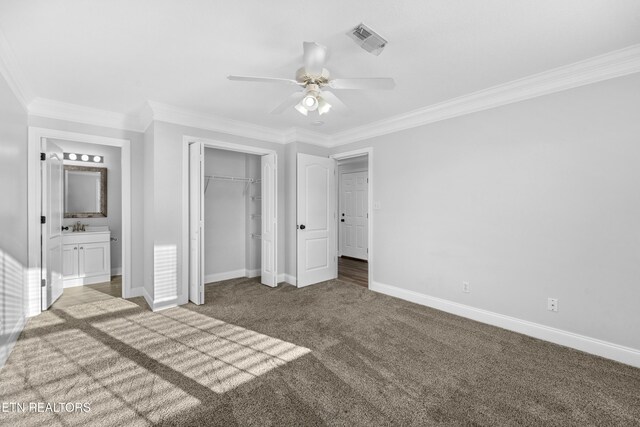 unfurnished bedroom featuring baseboards, ornamental molding, carpet flooring, and visible vents