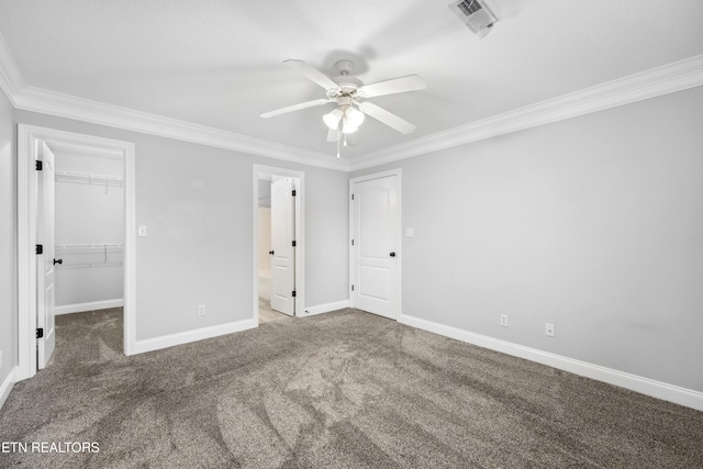 unfurnished bedroom featuring crown molding, carpet, and baseboards