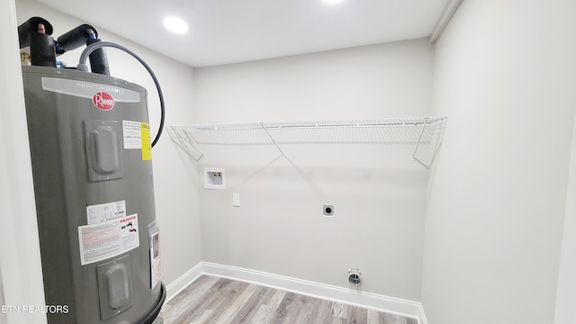 washroom featuring laundry area, washer hookup, light wood finished floors, water heater, and hookup for an electric dryer