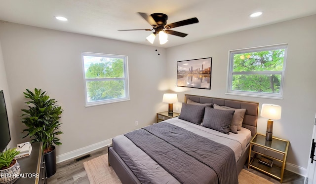 bedroom featuring baseboards, recessed lighting, and wood finished floors