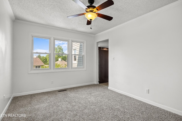 carpeted empty room featuring crown molding, a ceiling fan, a textured ceiling, and visible vents