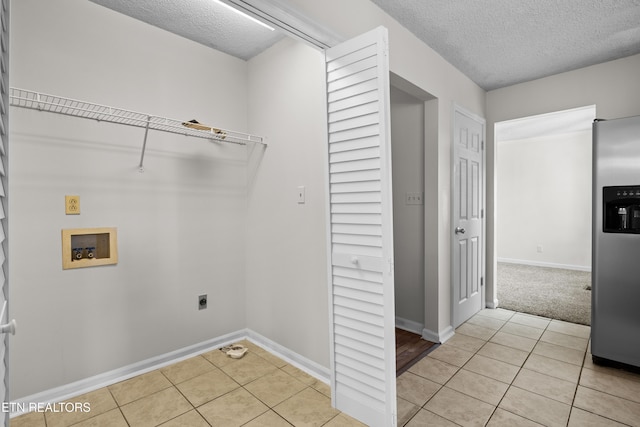 laundry room with light tile patterned floors, washer hookup, hookup for an electric dryer, and laundry area