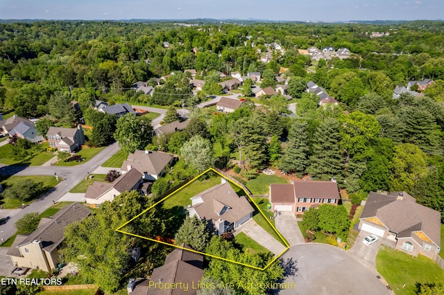 aerial view with a wooded view and a residential view