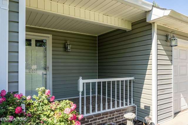 view of exterior entry featuring covered porch