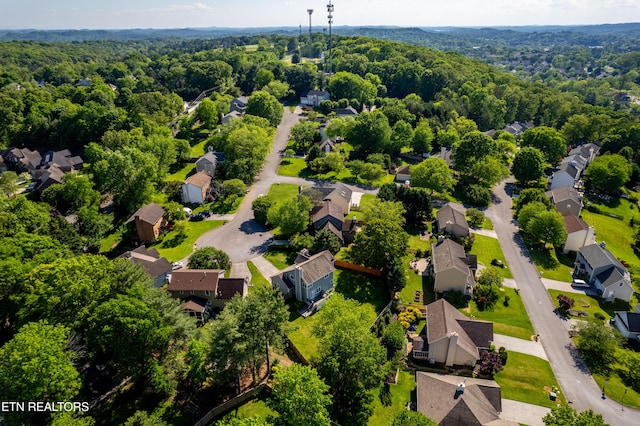 bird's eye view featuring a forest view and a residential view
