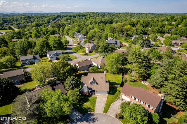 birds eye view of property with a residential view and a wooded view