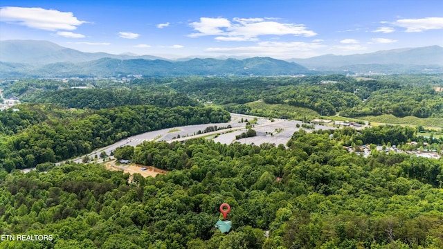 drone / aerial view featuring a mountain view and a forest view