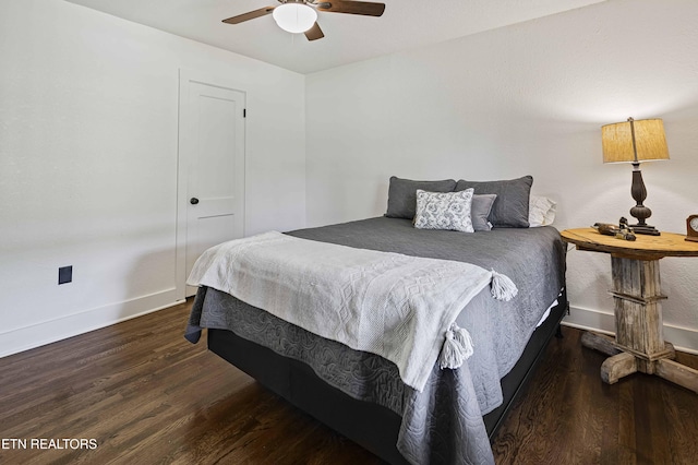 bedroom with a ceiling fan, wood finished floors, and baseboards