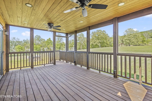 unfurnished sunroom with a wealth of natural light and a ceiling fan