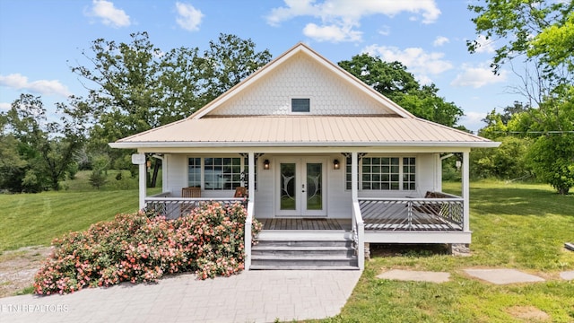 2738 Indian Creek Rd, Dandridge, TN 37725 - view of front of home with covered porch, french doors, metal roof, and a front lawn