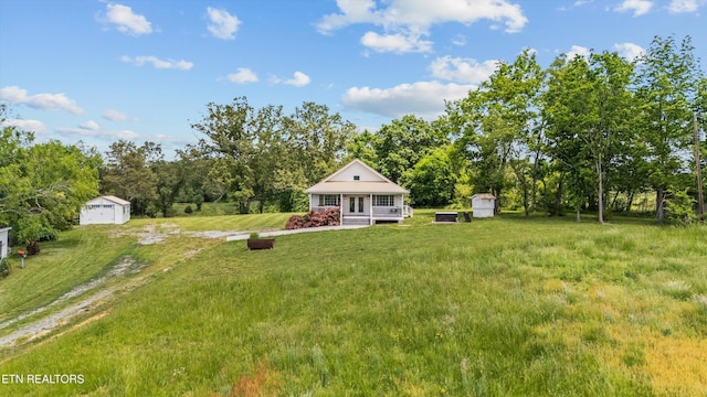2738 Indian Creek Rd, Dandridge, TN 37725 - exterior space featuring dirt driveway, an outbuilding, a detached garage, and a storage unit