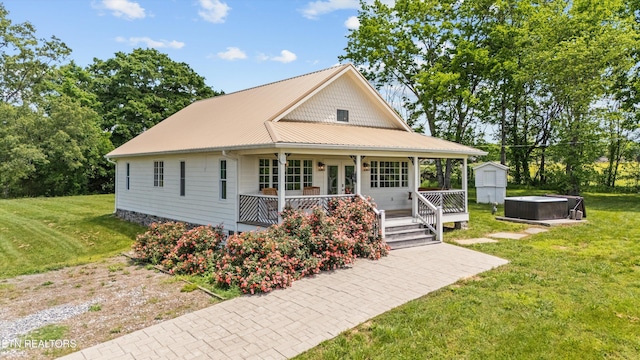 2738 Indian Creek Rd, Dandridge, TN 37725 - view of front of property with a porch, metal roof, a front yard, an outdoor structure, and a shed