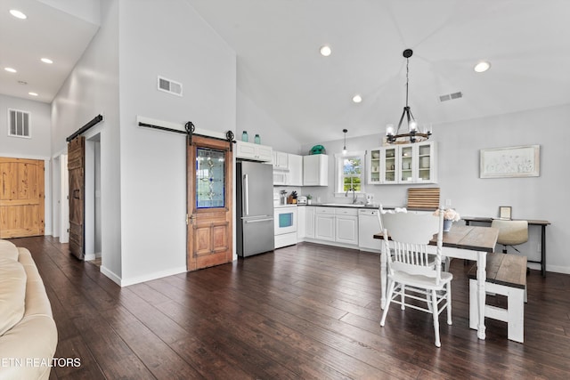 2738 Indian Creek Rd, Dandridge, TN 37725 - dining space featuring visible vents, a barn door, dark wood-style floors, and high vaulted ceiling