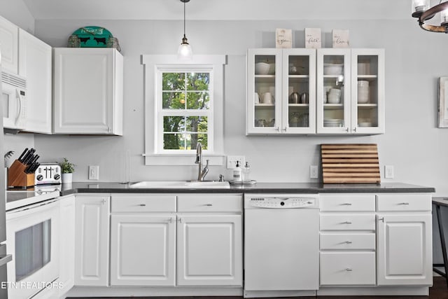 2738 Indian Creek Rd, Dandridge, TN 37725 - kitchen with dark countertops, a sink, white cabinets, glass insert cabinets, and white appliances