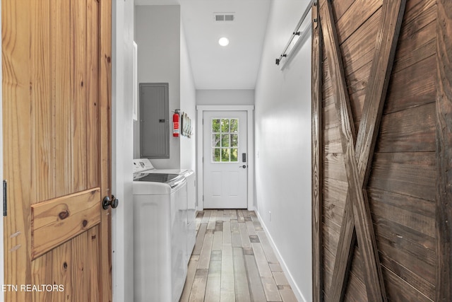2738 Indian Creek Rd, Dandridge, TN 37725 - clothes washing area with laundry area, visible vents, electric panel, separate washer and dryer, and light wood-style flooring