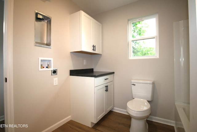 bathroom with a tub, walk in shower, wood finished floors, baseboards, and toilet