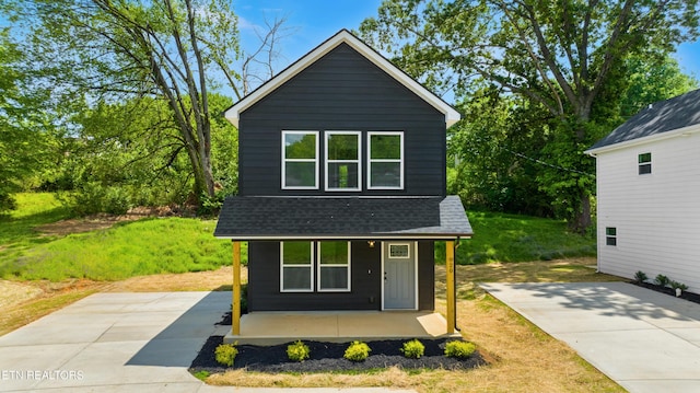 view of front of home featuring covered porch and roof with shingles
