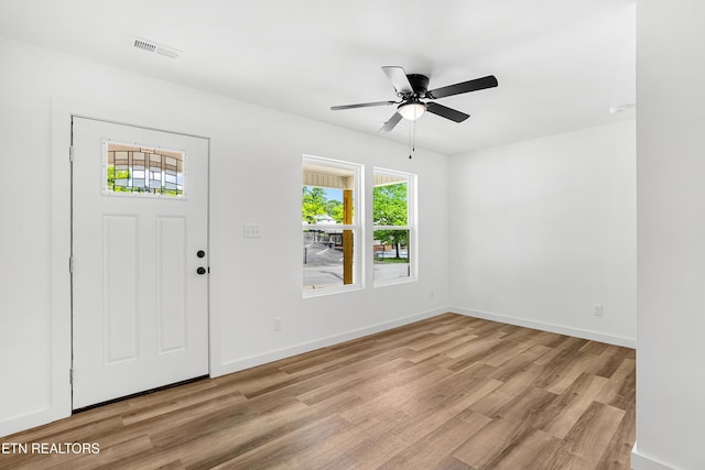 entryway with light wood finished floors, plenty of natural light, visible vents, and a ceiling fan