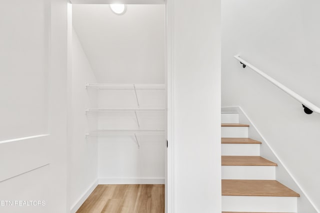 stairs with baseboards and wood finished floors