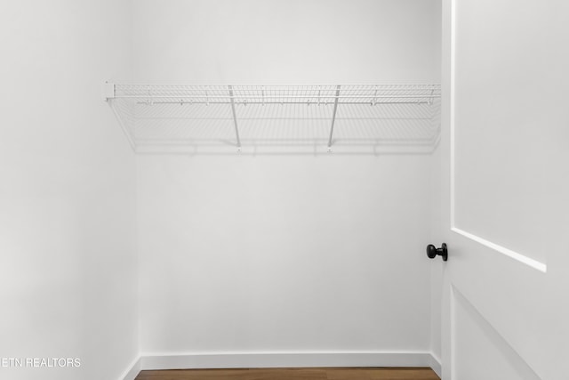 walk in closet featuring wood finished floors