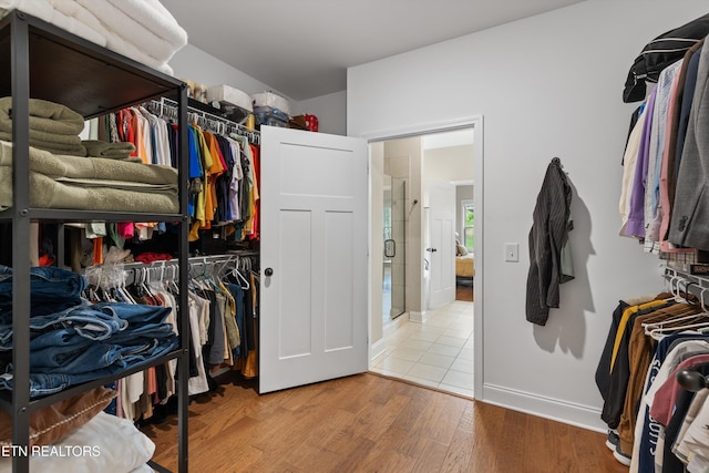 walk in closet featuring wood finished floors