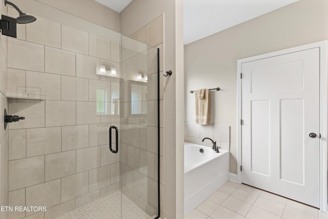 full bath with a shower stall, a bath, and tile patterned floors