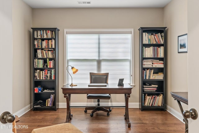 home office featuring baseboards and wood finished floors