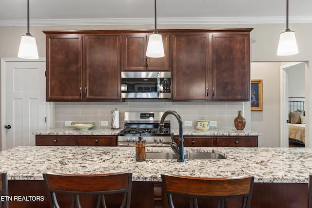 kitchen with ornamental molding, backsplash, dark brown cabinets, and appliances with stainless steel finishes