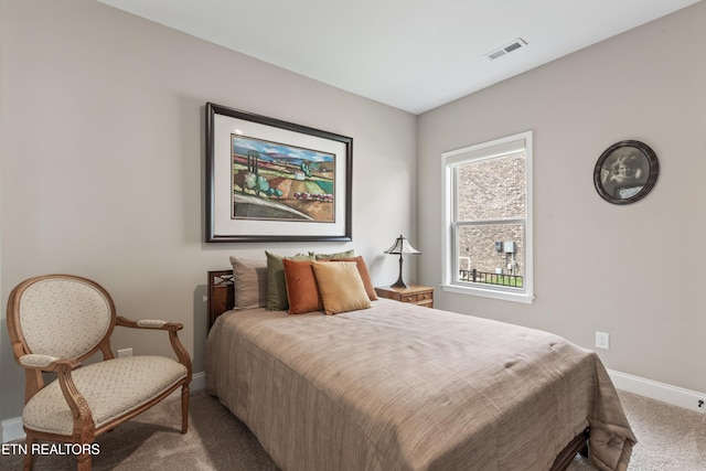 bedroom with baseboards, carpet flooring, and visible vents