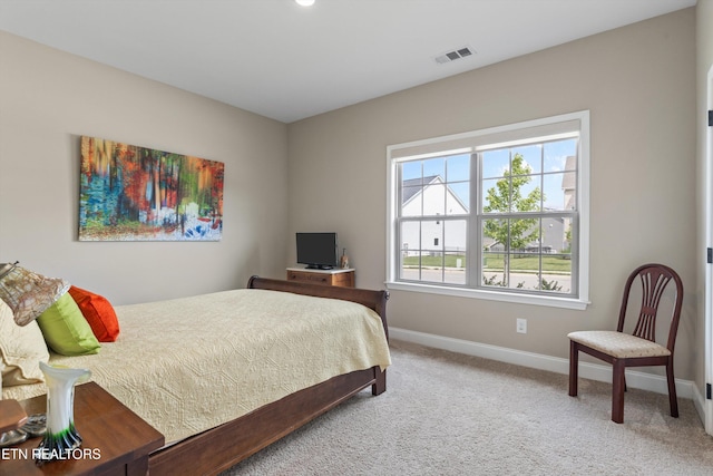 bedroom featuring carpet flooring, visible vents, and baseboards