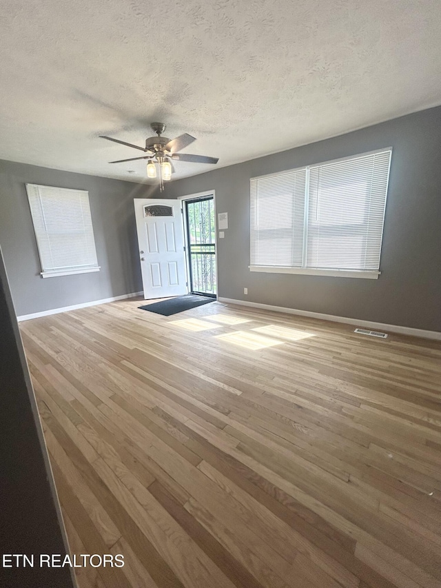 526 S Castle St, Knoxville, TN 37914 - interior space with baseboards, a textured ceiling, ceiling fan, and wood finished floors