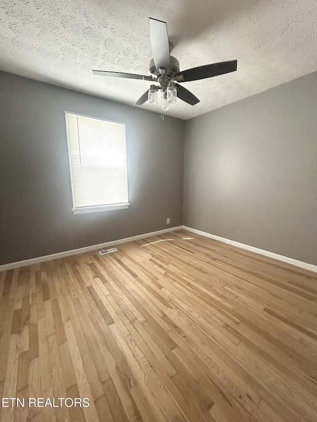 526 S Castle St, Knoxville, TN 37914 - empty room featuring baseboards, ceiling fan, light wood-type flooring, and a textured ceiling