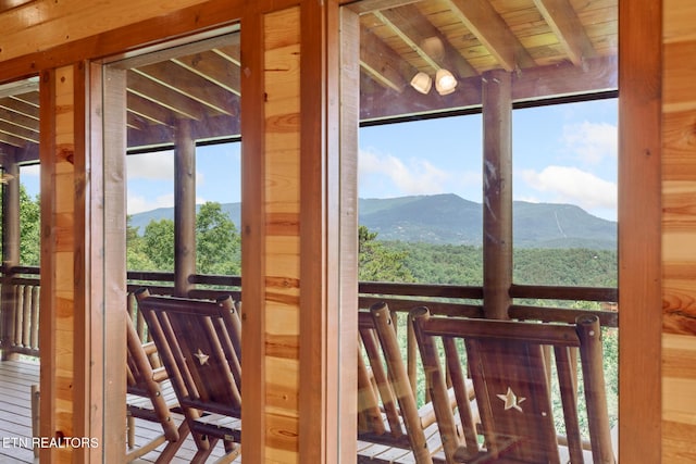 entryway featuring a mountain view, wood ceiling, and beam ceiling
