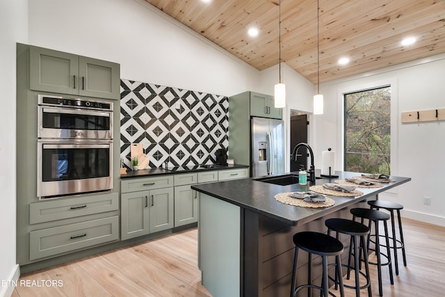 - Chinquapin Drive, Sevierville, TN 37876 - kitchen with dark countertops, a sink, wooden ceiling, light wood finished floors, and stainless steel appliances