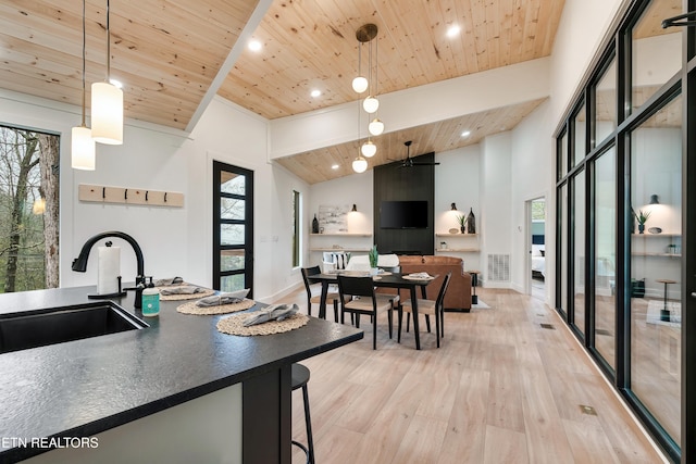- Chinquapin Drive, Sevierville, TN 37876 - kitchen with dark countertops, light wood-type flooring, wooden ceiling, a sink, and vaulted ceiling