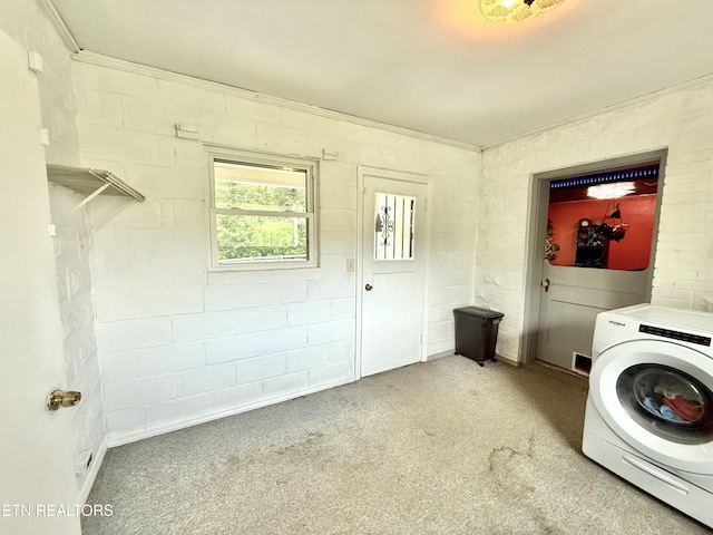 clothes washing area with washer / clothes dryer, laundry area, and carpet flooring