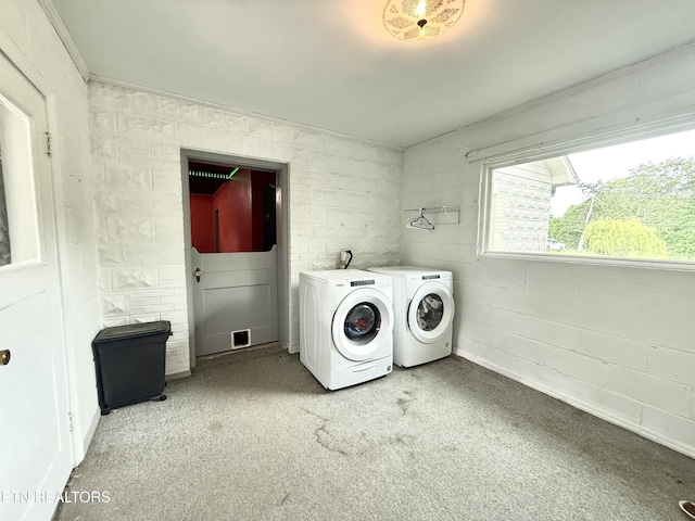 washroom with laundry area, washing machine and dryer, and light carpet