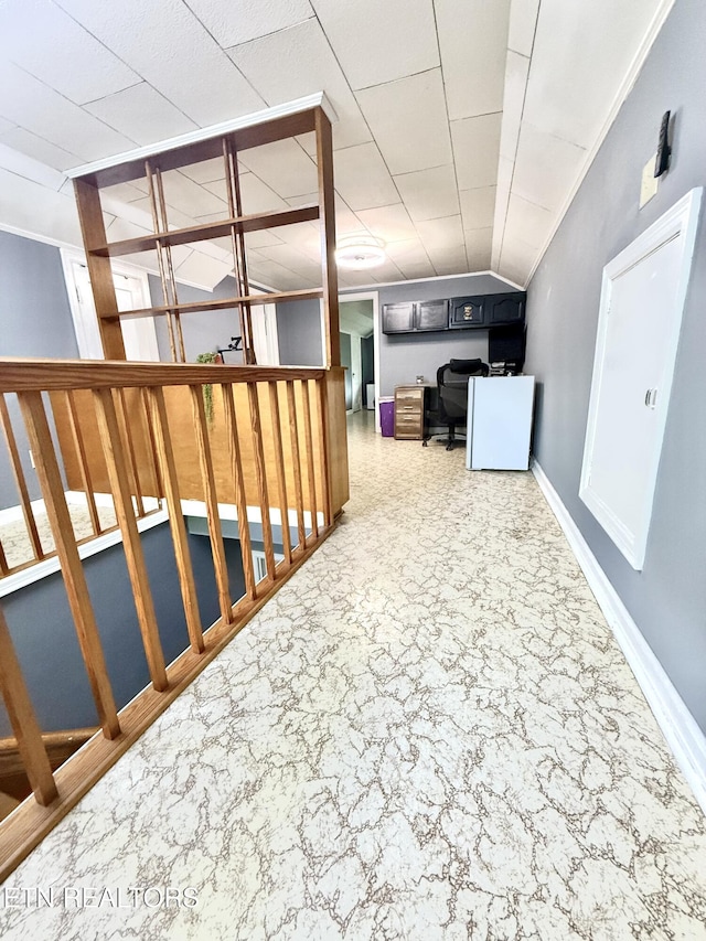 basement featuring baseboards and crown molding