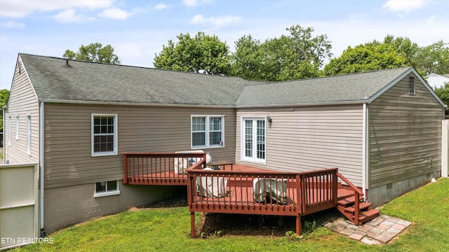 back of property featuring a yard, a deck, a shingled roof, and crawl space