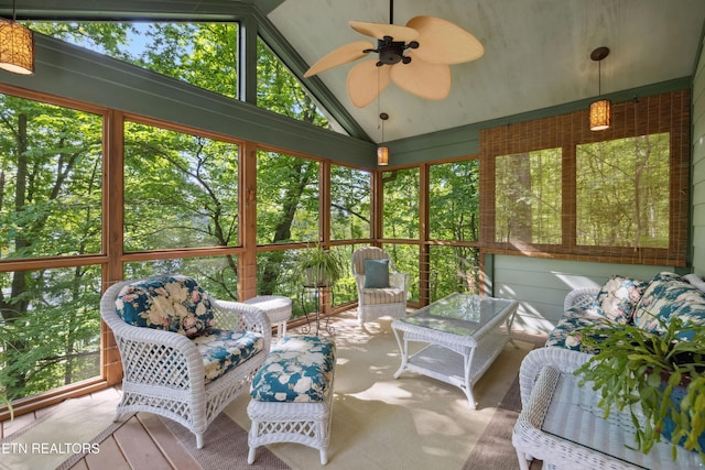 sunroom featuring ceiling fan, vaulted ceiling, and healthy amount of natural light