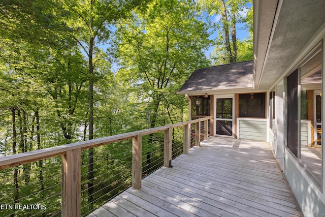wooden terrace featuring a sunroom