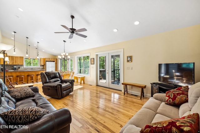 living room with vaulted ceiling, ceiling fan, light wood finished floors, plenty of natural light, and recessed lighting