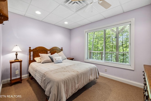 carpeted bedroom with baseboards, a paneled ceiling, and recessed lighting
