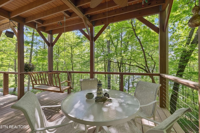 wooden deck featuring outdoor dining area